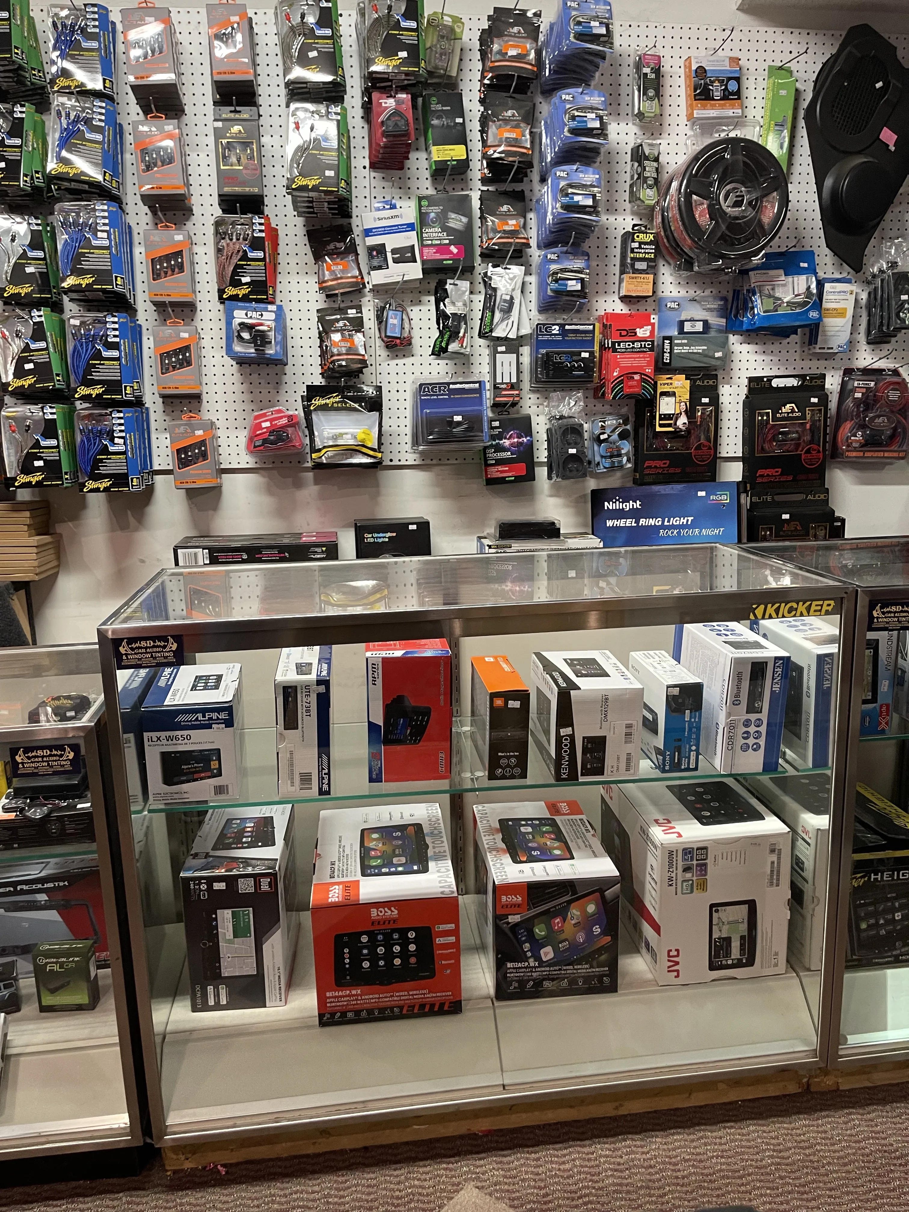 Store counter showing various car audio products.